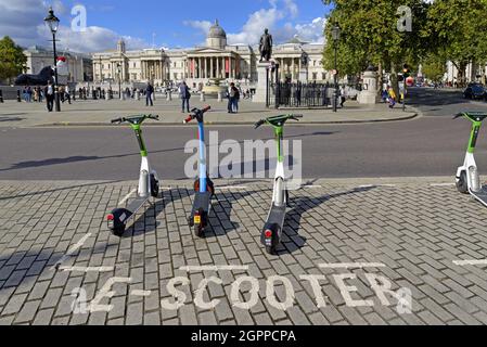 London, England, UK. E-scooters for hire in Trafalgar Square Stock Photo