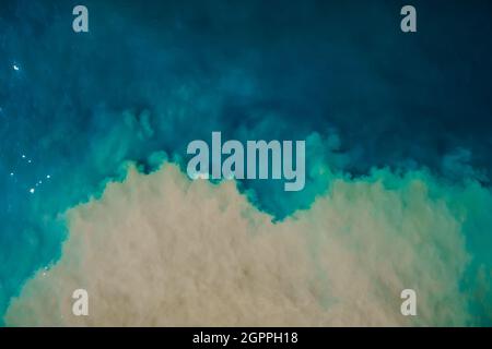 Aerial view of mixing blue and dirty water in sea. Natural abstract background Stock Photo