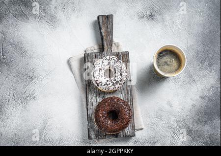 Fresh Chocolate artisan donuts and take away coffee. White background. Top view Stock Photo