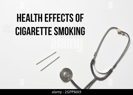 Stethoscope with two cigarettes on white background symbolic to quit smoking concept Stock Photo
