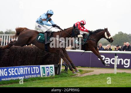 Fat Sam ridden by jockey James Davies (left) clear a fence on their way to winning the Colliers Saves Business Rates Handicap Chase at Warwick Racecourse. Picture date: Thursday September 30, 2021. Stock Photo