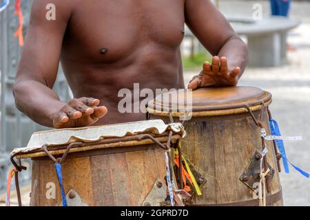 Musician playing atabaque which is a percussion instrument of African origin used in samba, capoeira, umbanda, candomble and various cultural, artisti Stock Photo