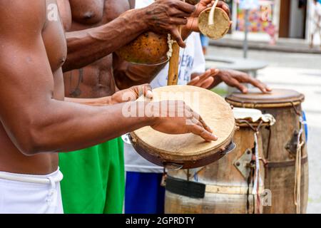 Musicians playing typical instruments of African origin used in capoeira and other Brazilian cultural events nas ruas de Salvador na Bahia Stock Photo