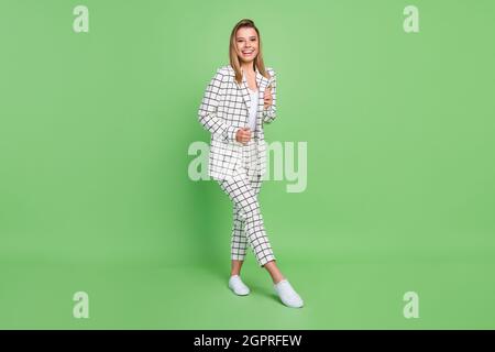 Full length body size view of attractive cheerful classy businesswoman posing having fun isolated over bright green color background Stock Photo