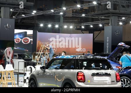 Barcelona, Spain. 30th Sep, 2021. People stand at the Mercedes-Benz stand before the official start of the car show. The 'Automobile Barcelona' trade fair takes place from 2 to 10 October. Credit: Clara Margais/dpa/Alamy Live News Stock Photo