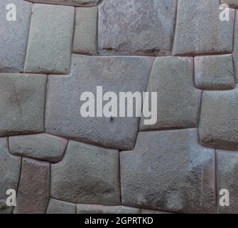 Detail of Inca's perfect stonework. Wall of former palace of Inca Roca in Cuzco, Peru. Stock Photo