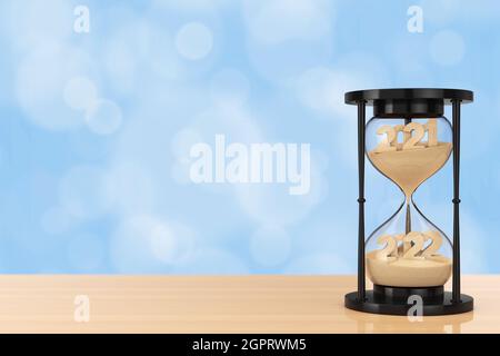 New 2022 Year Concept. Sand Falling in Hourglass Taking the Shape from 2021 to 2022 year on a wooden table. 3d Rendering Stock Photo