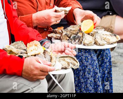 Midsection Of Man Holding Ice Oyster On The Knees, Ready To Eat