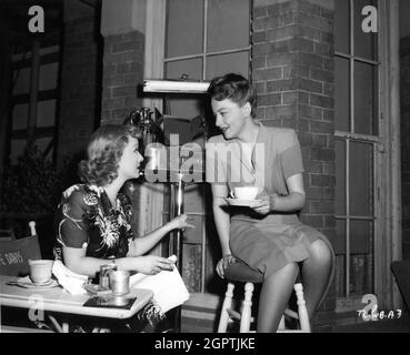 BETTE DAVIS and OLIVIA de HAVILLAND on set candid during filming of IN THIS OUR LIFE 1942 director JOHN HUSTON novel Ellen Glasgow screenplay Howard Koch music Max Steiner gowns Orry-Kelly Warner Bros. Stock Photo