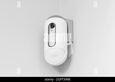 Surveillance camera with presence sensor on the wall Stock Photo