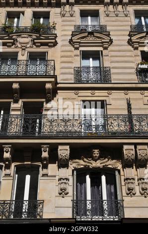 The facade of a residential building in the Marais, a historic district in Paris on the Right Bank of the River Seine. Stock Photo