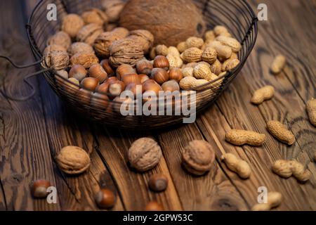 different kinds of nuts on a wooden background Stock Photo