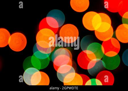 blurred defocused christmas lights bokeh on a black background Stock Photo