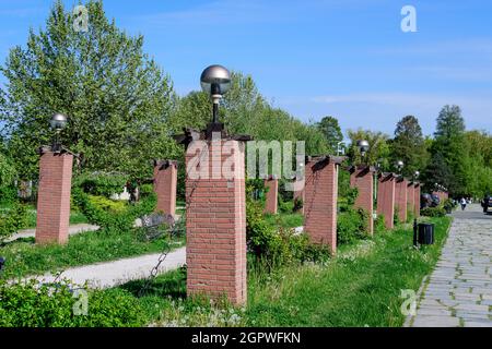 Landscape with the main alley and many large green trees in King Michael I Park (Herastrau), in a sunny spring day Stock Photo