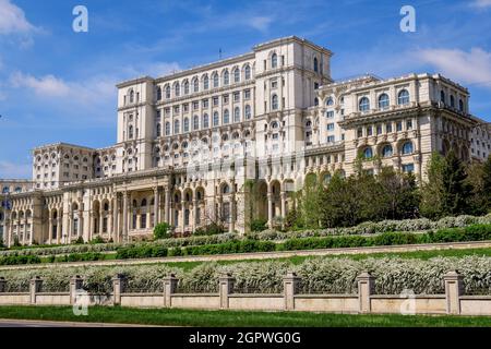 The Palace of the Parliament also known as People's House (Casa Popoprului) in Constitutiei Square (Piata Constitutiei) in Bucharest, Romania, in a su Stock Photo