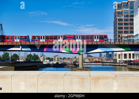 metro entering the station located inside the modern skyscrapers at Docklands area in Canary wharf district, London UK. Stock Photo