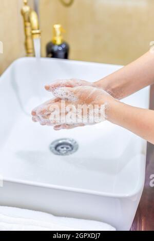 Woman Washing And Disinfecting Hands With Soap And Hot Water As Part Of Coronavirus Preventio.