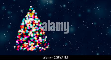 Christmas tree made of colorful defocused Christmas lights at snowing night. Copy space Stock Photo