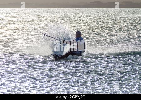 CABO DE LA VELA, COLOMBIA - AUGUST 23, 2015: Kitesurfer in a sea near village Cabo de la Vela located on La Guajira peninsula. Stock Photo