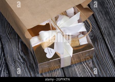 Homemade marshmallows in a craft box and paper bag. Marshmallow in a waffle cone. Made in the shape of a rose. Close-up shot. Stock Photo