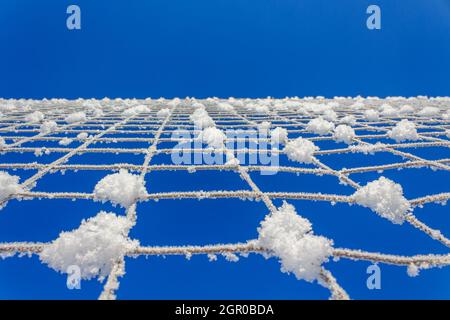 Volleyball net covered with snow. Nature's minimalism.  Stock Photo