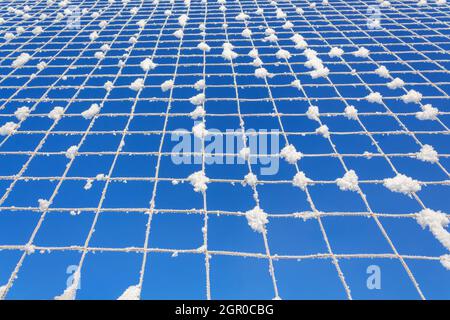 Volleyball net covered with snow. Nature's minimalism.  Stock Photo