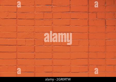 matte orange painted brick wall full frame flat background and texture Stock Photo