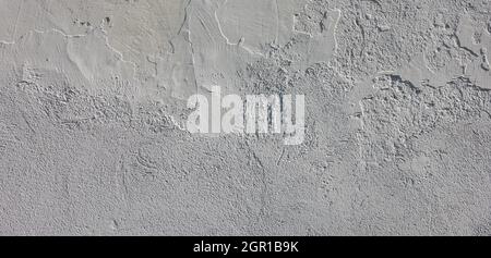 rough whitewash flat wall under direct sun light - full frame background and texture Stock Photo