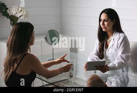 A young woman doctor consulting a young woman Stock Photo