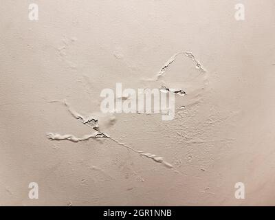 texture of a painted wall with a flaking and cracking defect caused by humidity, chipping and cracks, horizontal Stock Photo