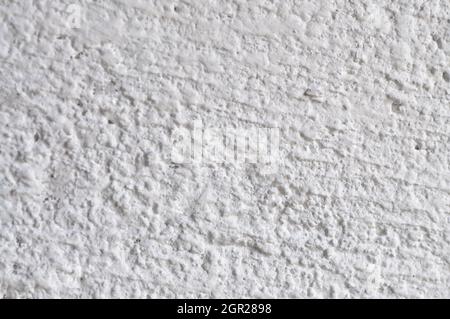 Harsh white plaster on the wall. White concrete wall texture. Stock Photo