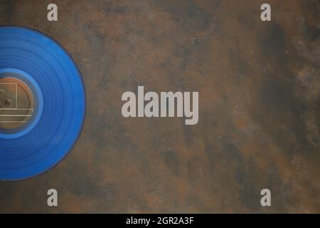 Blue Vinyl record on a rusty background. Retro style. Top view Stock Photo