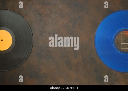 Vinyl record on a rusty background. Retro style. Top view. Stock Photo