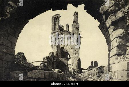 A historical view of the devistated belfrey tower of Ypres Cathedral seen through an archway, heavily damaged by shell fire during the First World War. Taken c.1918. Stock Photo