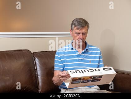 Morgantown, WV - 28 September 2021: Senior man examining Oculus Quest 2 VR headset box Stock Photo