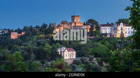 Panoramic view at dusk of the monumental complex of Tomar Castle, Convent of Christ and the Chapel of Nossa Senhora da Conceição, in the city of Tomar Stock Photo