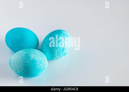 Three Beautiful Painted Blue Easter Eggs Close-up On A White Background.