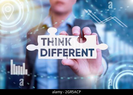 Hand writing sign Think Different. Business showcase unusual method or practice that showing use to think Business Woman Holding Jigsaw Puzzle Piece Stock Photo