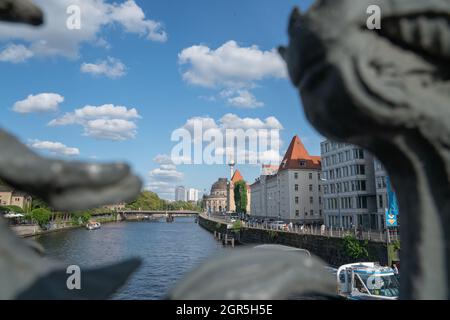 Berlin Germany - August 26 2017; View through decorative railing of Ebert Bridge across River Spree to famous buildings of orange roof of Alexander Ka Stock Photo