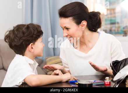 Smiling mother talking with son Stock Photo