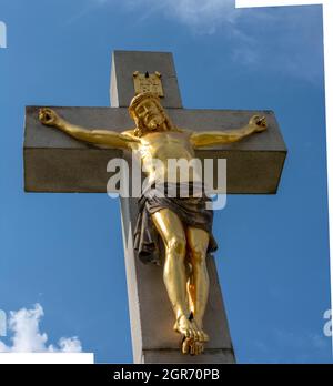 Golden crucified Jesus Christ on the cross. Close up. Detail. Nitra Calvary. Slovakia. Stock Photo