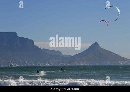 Cape Town, South Africa. 30th Sep, 2021. Surfers enjoy kitesurfing on the sea in Cape Town, South Africa, Sept. 30, 2021. Credit: Chen Cheng/Xinhua/Alamy Live News Stock Photo