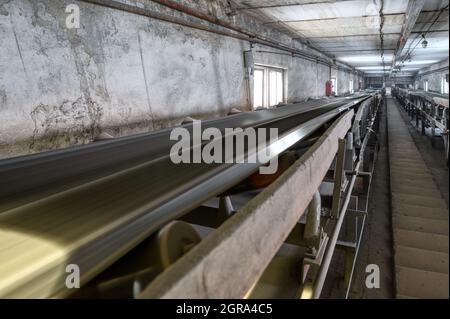 Belt conveyor system in an underground tunnel. Transportation of ore to the surface Stock Photo