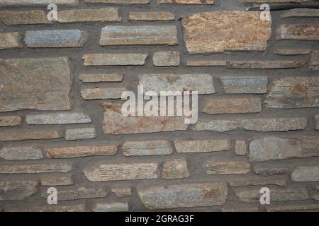 rustic wall of uneven stones Stock Photo