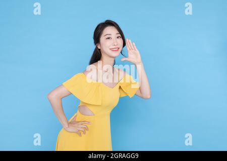 shopping event concept, smiling beautiful Korean Asian woman with hand motion, shouting pose Stock Photo