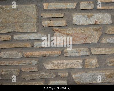 rustic wall of uneven stones Stock Photo