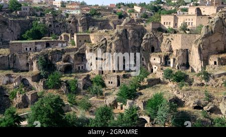 cliff dwelling in Turkey rock cut cave houses of Guzelyurt in central Anatolia Stock Photo