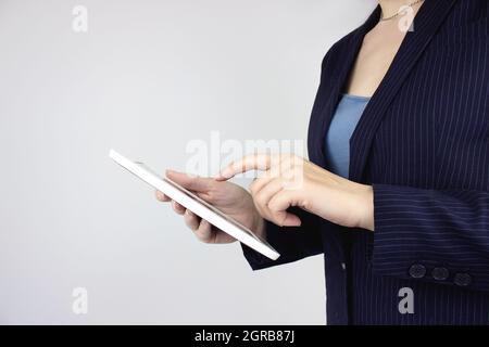 Woman hand touching a digital tablet. Concept of technology, connection, communication, social Stock Photo