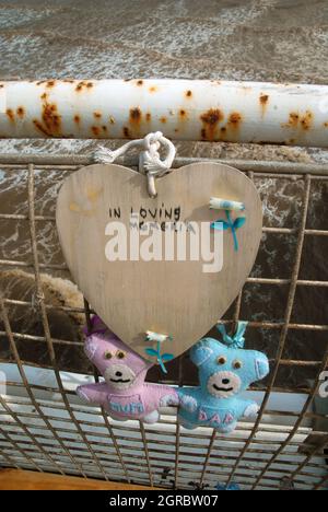 Mum and Dad bears tied to railings of North Pier as a memorial, Blackpool, Lancashire, UK. Stock Photo