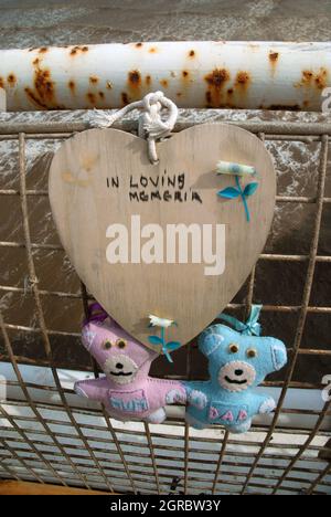 Mum and Dad bears tied to railings of North Pier as a memorial, Blackpool, Lancashire, UK. Stock Photo